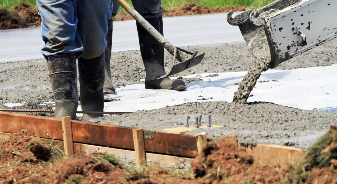 A residential concrete slab poured using lower-impact materials