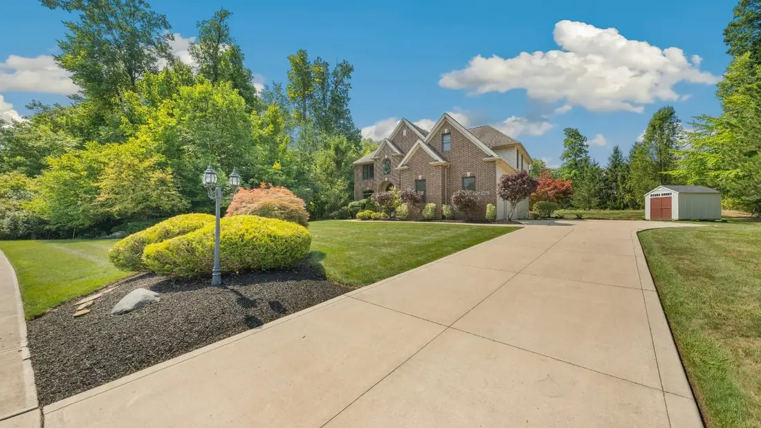 A finished concrete driveway leading to a home