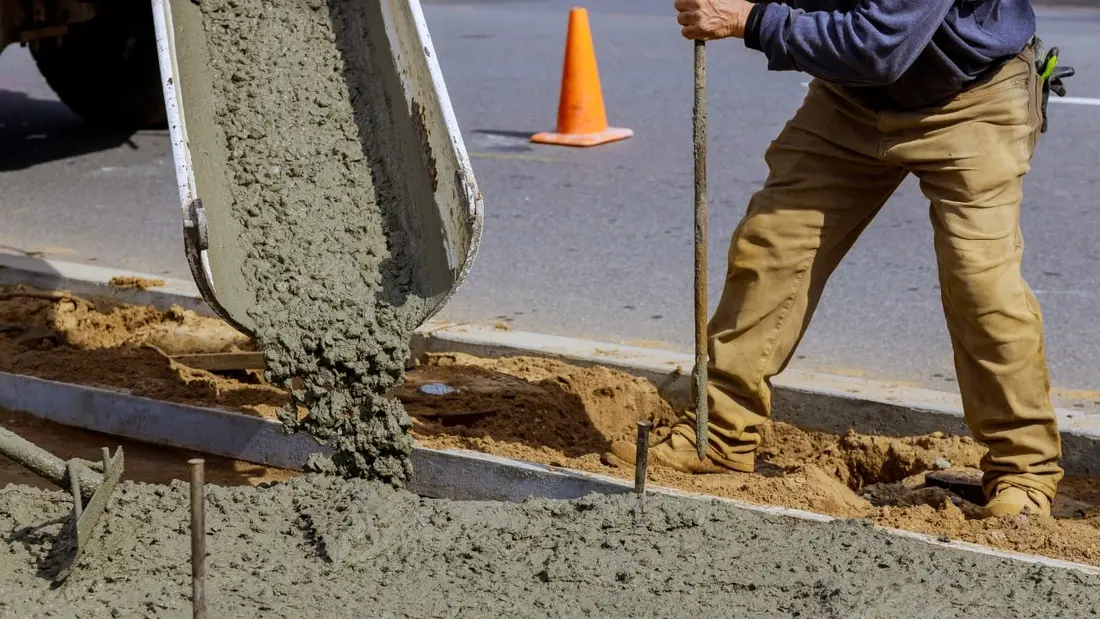 Fresh concrete being poured and finished on a residential site