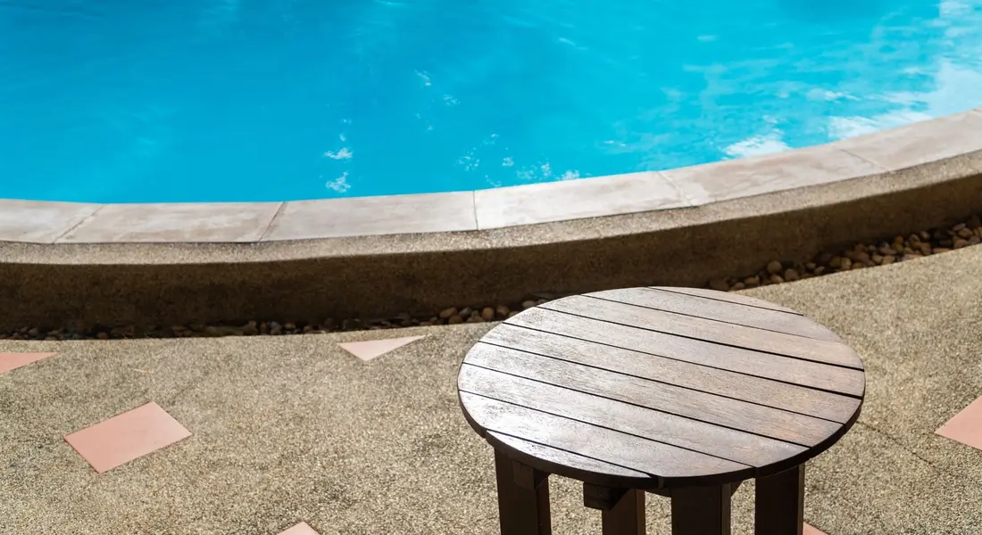 A concrete pool deck with a textured, slip-resistant finish