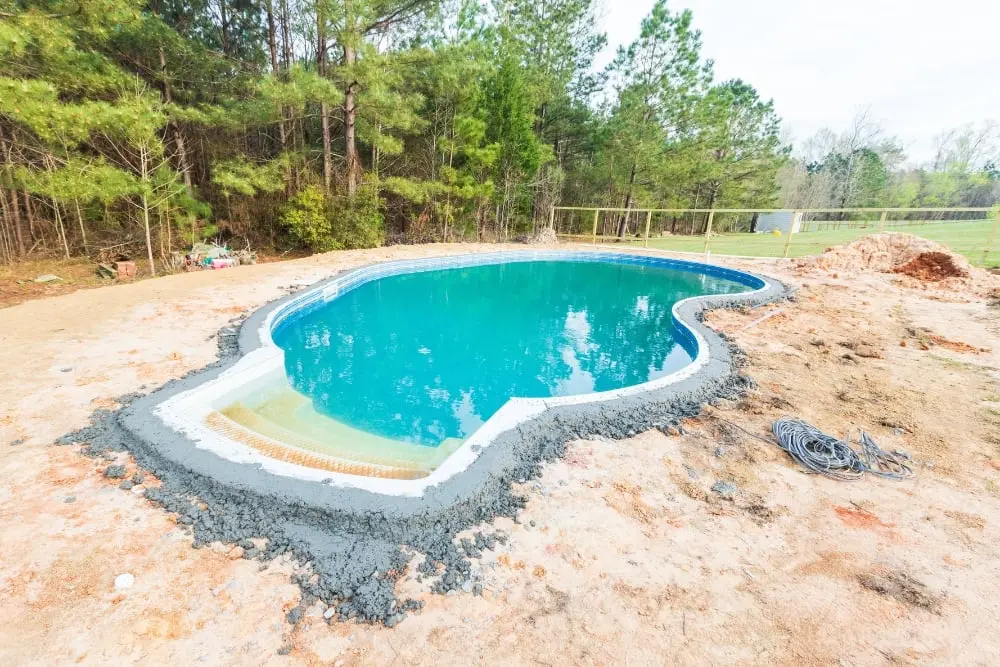 The concrete bond beam edge of a residential swimming pool