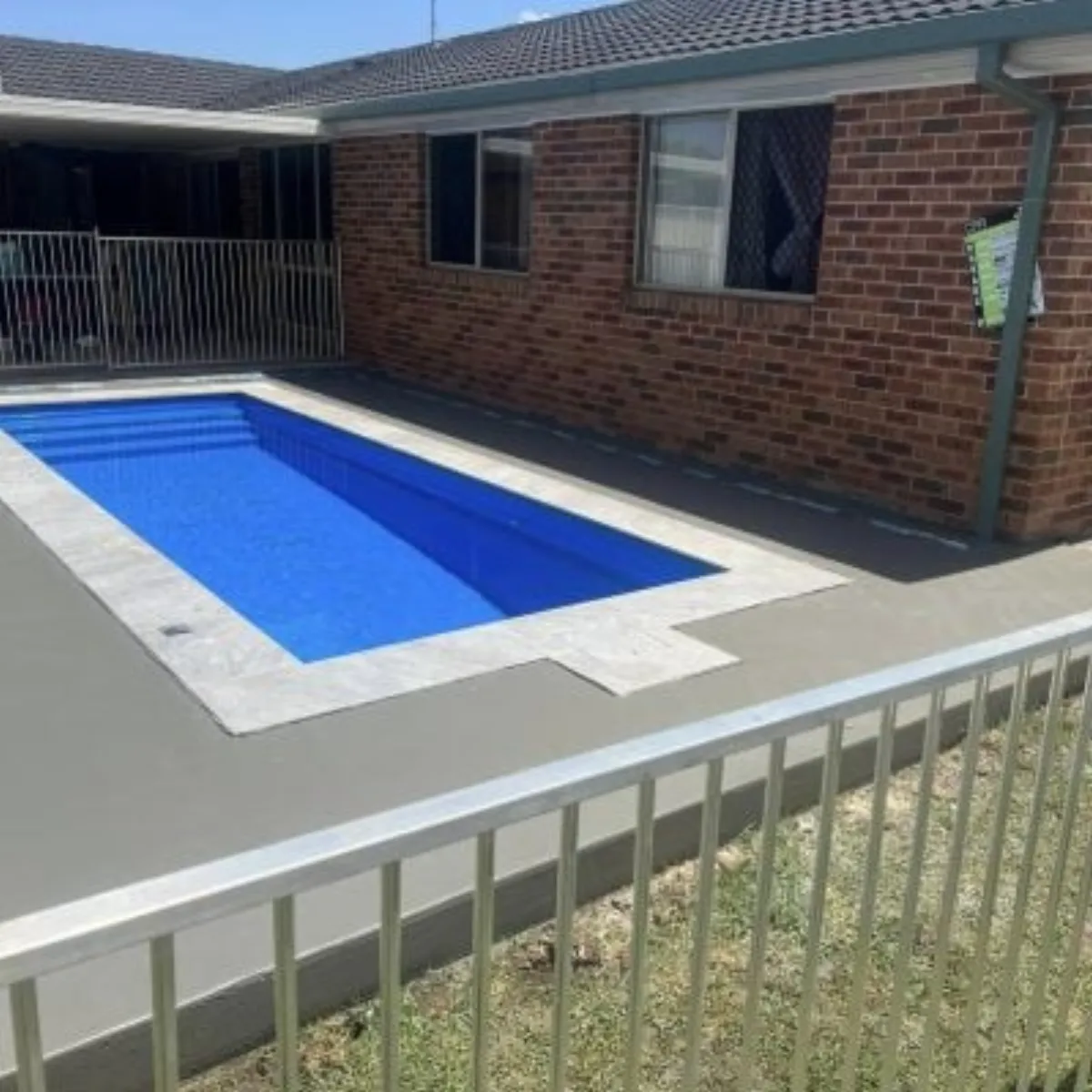 A concrete pool surround finished by the crew