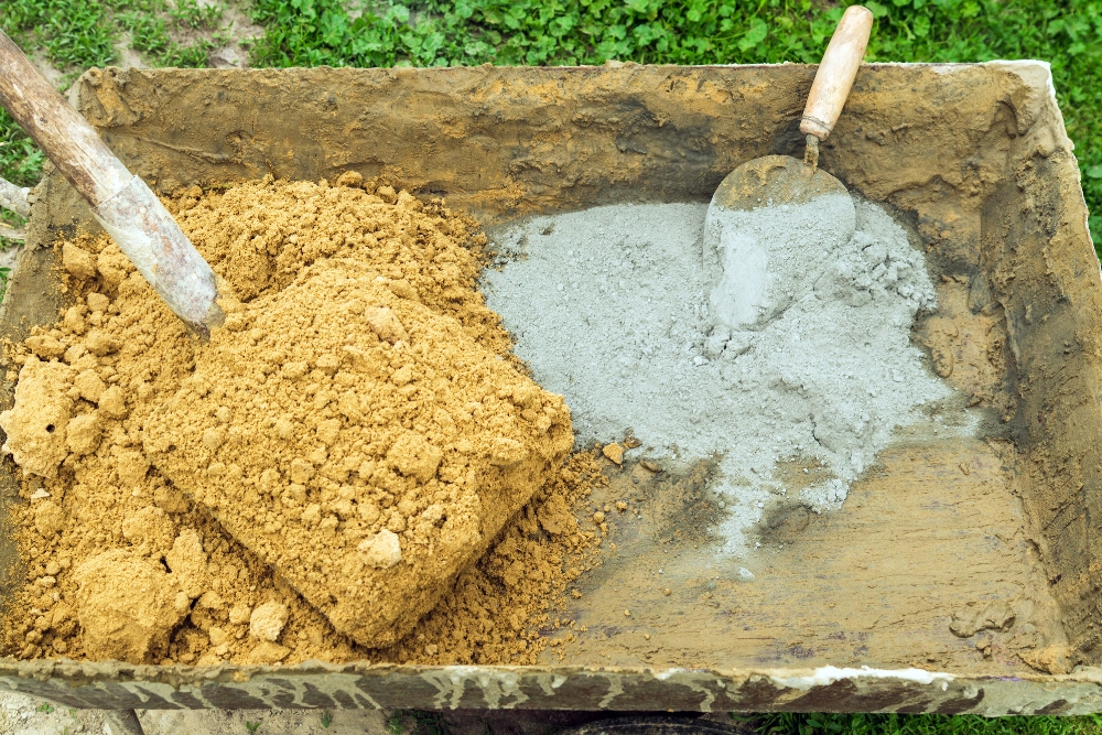 Wheelbarrow with sand and cement for mixing